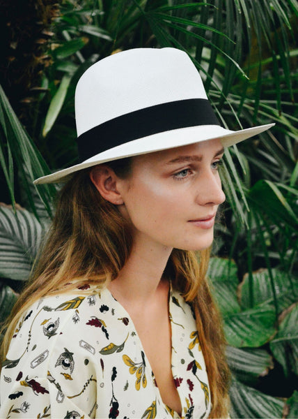 Young Woman wearing a classic white Panama hat with a black band