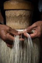 Artisan craftsmen weaving a panama hat by hand